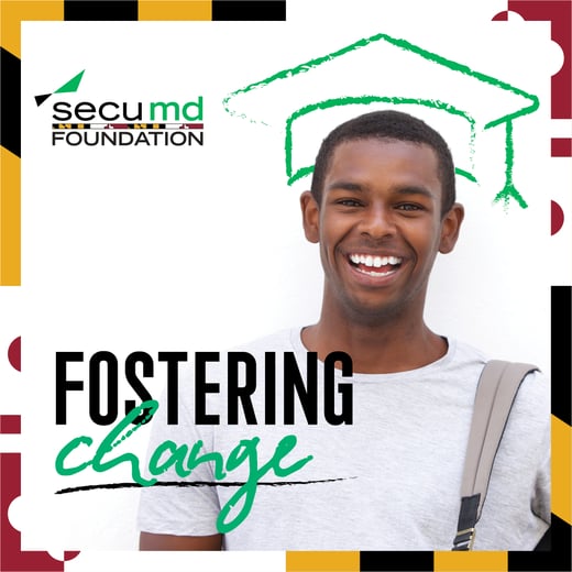Smiling graduate wearing a cap with “Fostering Change” text