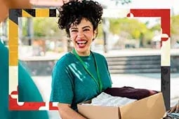 Woman smiling holding box