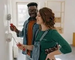 Couple working on home renovations together indoors